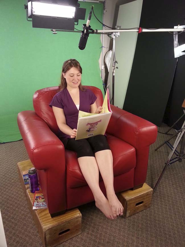 Lizi, prepares to read an online kids picture book that will be turned into an engaging video. Kids learn from word and picture